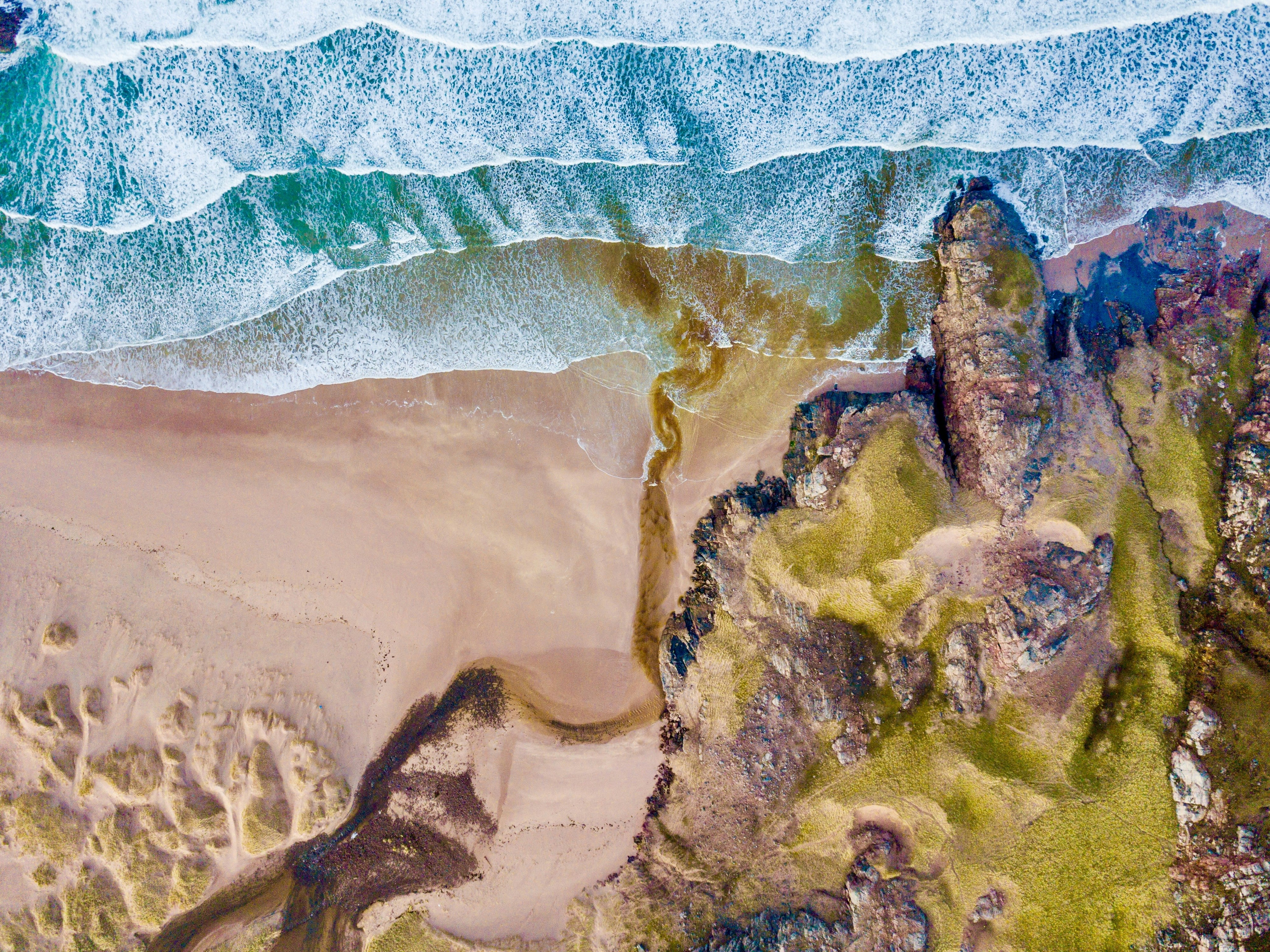 aerial photography of green mountain and seashore during daytime
