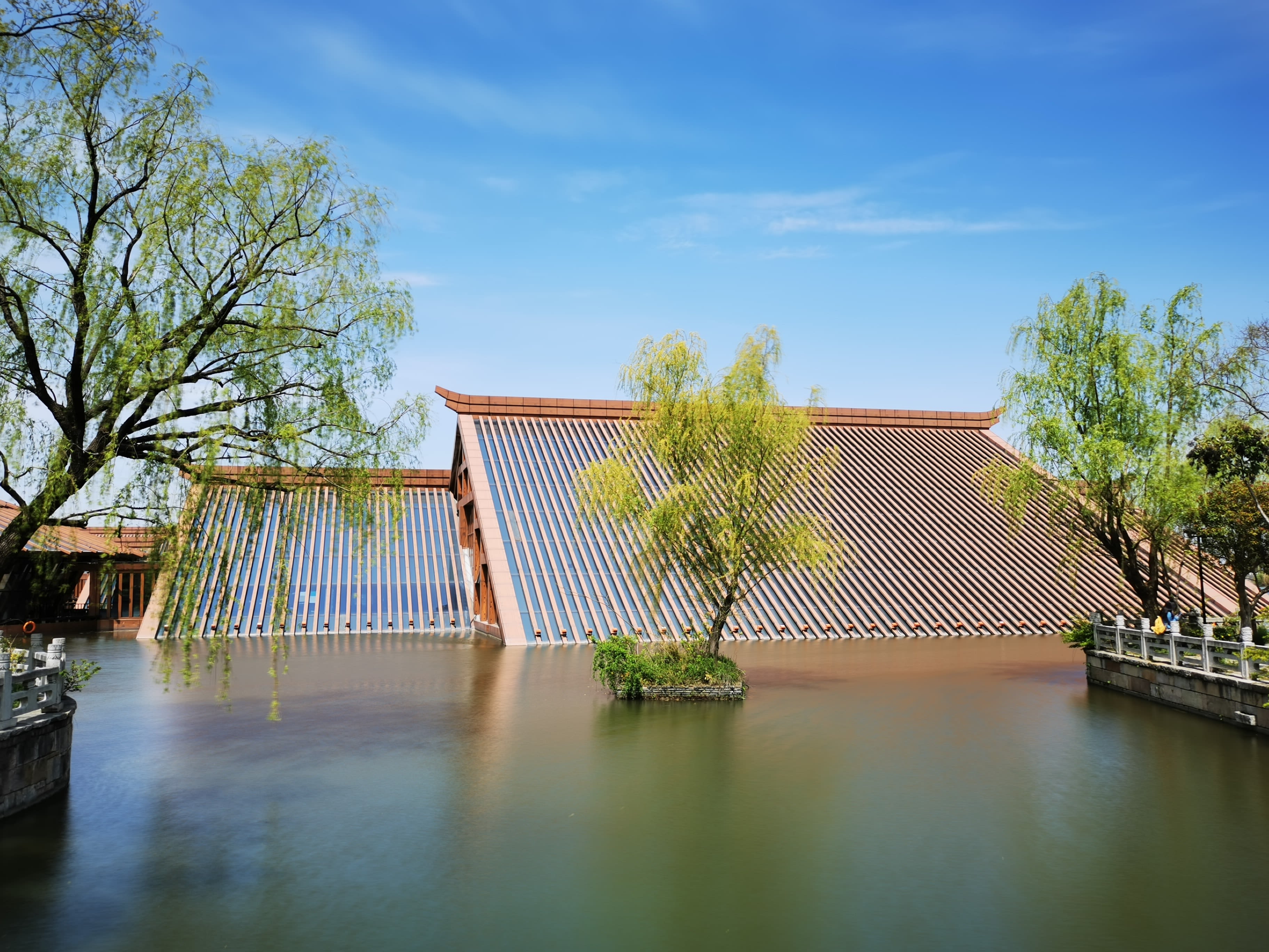 brown wooden fence near green trees and river during daytime