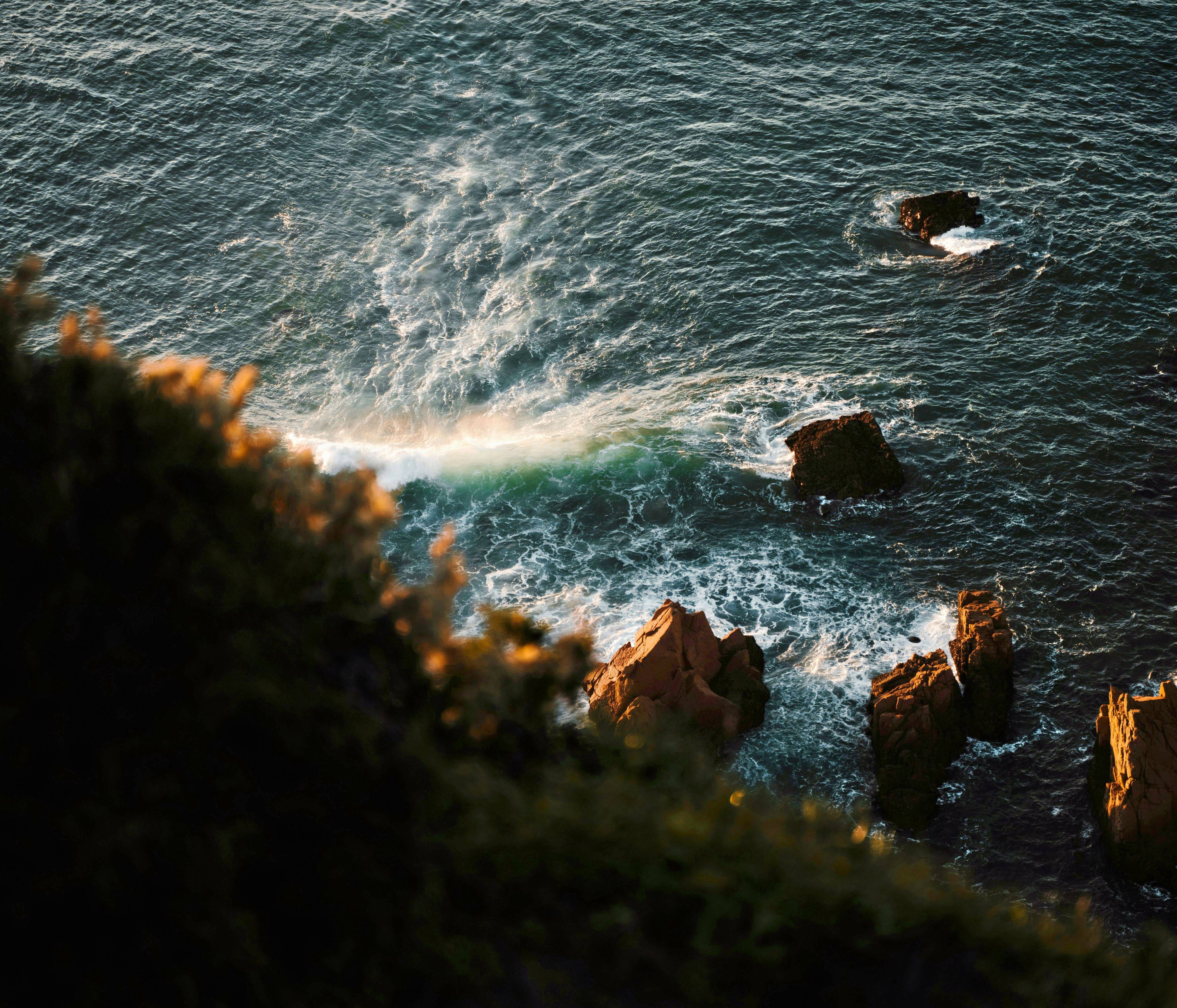 A body of water near a rocky shore