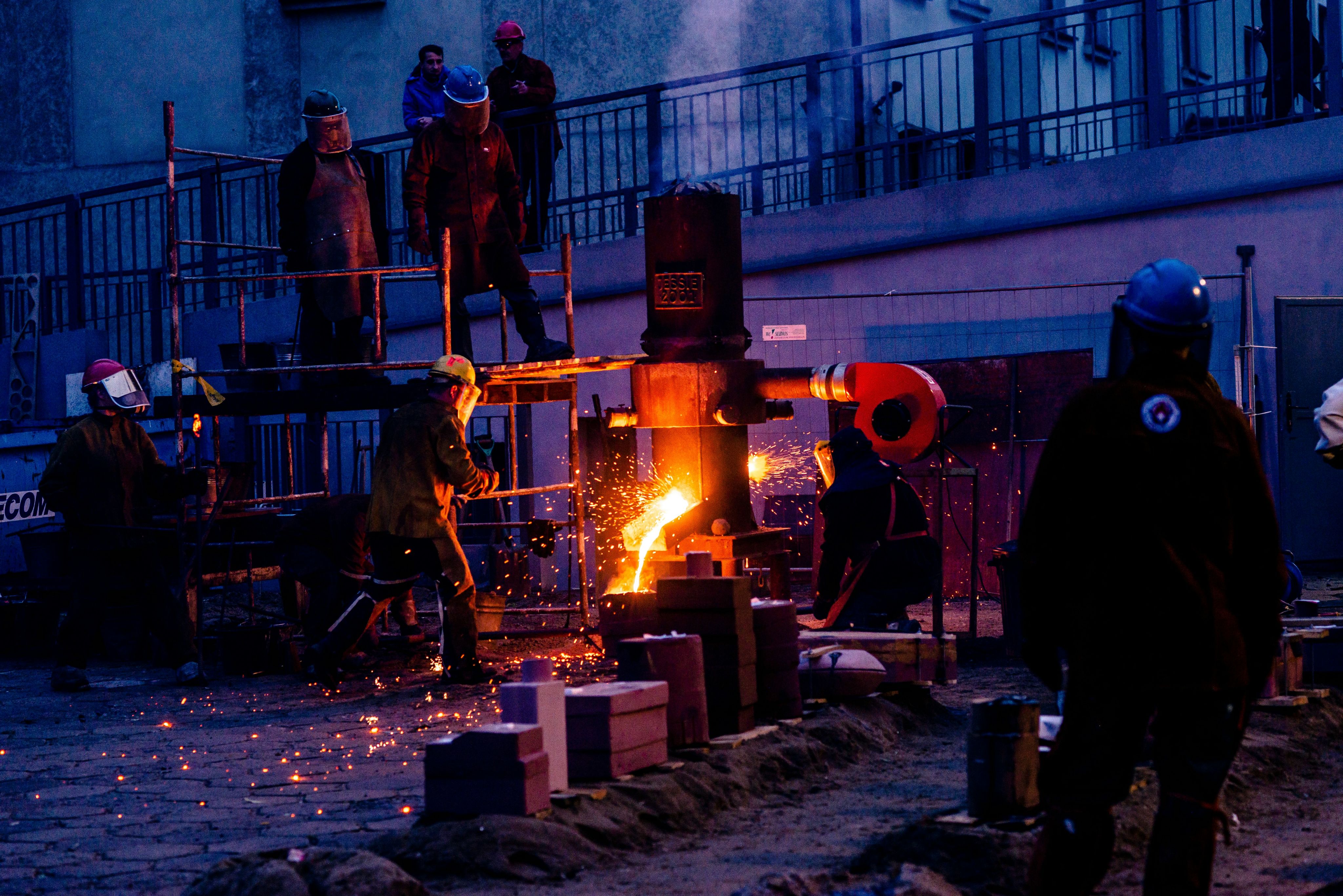 a group of people standing around a fire